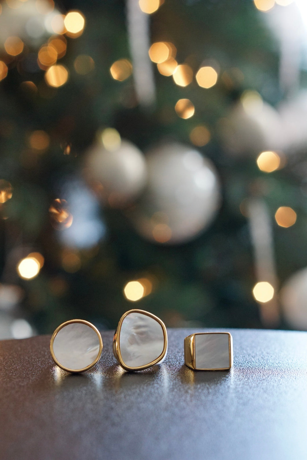  Lineup of 3 rings (from left to right): Aria, Elisa, and Camila rings with lit Christmas tree in background. 